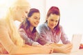 Smiling students with tablet pc computer at school Royalty Free Stock Photo