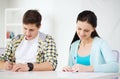 Smiling students with textbooks at school Royalty Free Stock Photo