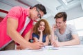 Smiling students working and taking notes together Royalty Free Stock Photo