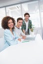 Smiling students working together on laptop Royalty Free Stock Photo