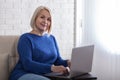 Smiling stylish mature middle aged woman sits with laptop, portrait. Happy older senior businesswoman, looking at camera Royalty Free Stock Photo