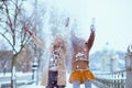 Smiling stylish mother and child throwing snow Royalty Free Stock Photo