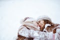 smiling stylish mother and daughter laying in snow Royalty Free Stock Photo