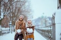 Smiling stylish mother and daughter throwing snow Royalty Free Stock Photo