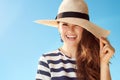 Stylish woman in straw hat against blue sky Royalty Free Stock Photo