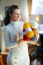 Smiling stylish woman holding basket with yarn and needles Royalty Free Stock Photo