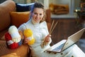 Smiling stylish woman with yarn learn how to knit Royalty Free Stock Photo