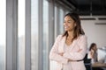 Smiling African American businesswoman standing in office, business vision