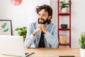 Smiling businessman looking away daydreaming while on a break from work. Royalty Free Stock Photo