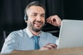 smiling support hotline worker with laptop and microphone Royalty Free Stock Photo