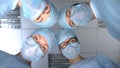 Smiling surgeon team faces, pov patient waking up after operation anesthesia