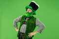 A man in a leprechaun hat at studio. He celebrates St. Patrick`s Day.