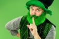 A man in a leprechaun hat at studio. He celebrates St. Patrick`s Day. Royalty Free Stock Photo