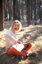 Smiling Surprised positive young girl with laptop outdoors Royalty Free Stock Photo