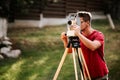 Smiling surveyor working with total station with coordinates, cartography industry details Royalty Free Stock Photo