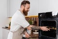 Smiling tattooed man putting food in