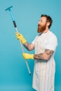 smiling tattooed man in striped apron