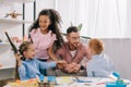 smiling teacher in eyeglasses and cheerful interracial kids Royalty Free Stock Photo