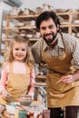 smiling teacher and happy child painting ceramic pot on pottery Royalty Free Stock Photo