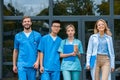 smiling teacher with multicultural students walking from Royalty Free Stock Photo