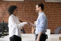 Smiling team leader is handshaking successful employee Royalty Free Stock Photo