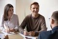 Smiling teammates discussing project with client at office. Royalty Free Stock Photo