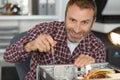 smiling technician assembling computer