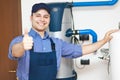 Smiling technician repairing thumbs up