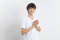 Smiling teen boy greeting with palms gesture pressed together