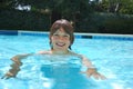 Smiling Teen Boy Swimming in Pool