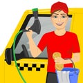 Smiling teen boy using a soapy sponge to wash a taxy car Royalty Free Stock Photo