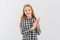 Smiling teen girl in casual plaid shirt, clap hands, applauding you and praising, looks happy, stands over white background