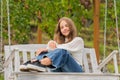 smiling teen girl having free time outside on swing, happiness Royalty Free Stock Photo