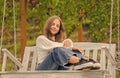 smiling teen girl having free time outside on swing, happiness Royalty Free Stock Photo