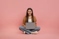 Smiling Teen Girl With Laptop Sitting On Floor Over Pink Background Royalty Free Stock Photo