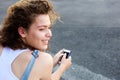 Smiling teen girl with smart phone outside