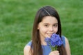 smiling teen girl smelling flowers. pretty girl on grass. cute girl portrait Royalty Free Stock Photo