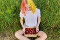 Smiling teen girl with strawberries in basket, garden nature background Royalty Free Stock Photo