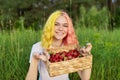 Smiling teen girl with strawberries in basket, garden nature background Royalty Free Stock Photo