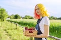 Smiling teen girl with strawberries in basket, garden nature background Royalty Free Stock Photo