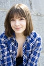 Smiling teen girl wearing chequered shirt