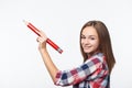 Smiling teen girl writing with big pencil on blank copy space Royalty Free Stock Photo