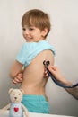 Smiling teenage boy at a doctor`s appointment at the clinic. The pediatrician Checking a child`s health Royalty Free Stock Photo