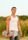 Smiling teenage boy with skateboard outdoors Royalty Free Stock Photo