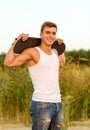 Smiling teenage boy with skateboard outdoors Royalty Free Stock Photo