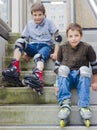 Smiling teenage boys in roller-blading protection kits