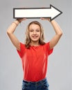 Smiling teenage girl with arrow showing direction Royalty Free Stock Photo