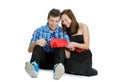 Smiling teenage girl and boy cutting valentine heart out of red paper with scissors Royalty Free Stock Photo