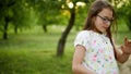 Smiling teenage girl dancing outside. Cheerful girs having fun otdoors