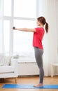 Smiling teenage girl exercising with dumbbells Royalty Free Stock Photo